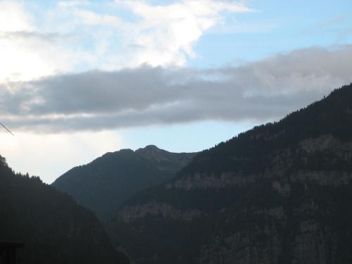 a view of a mountain range with clouds in the sky at Casa Danoli in Canale San Bovo