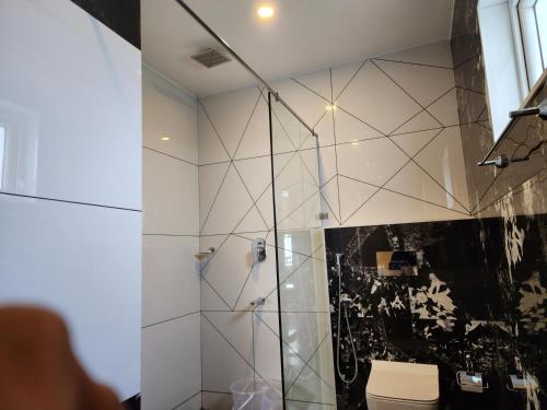 a bathroom with a shower and a toilet at Gee Resort & Heights in Idukki