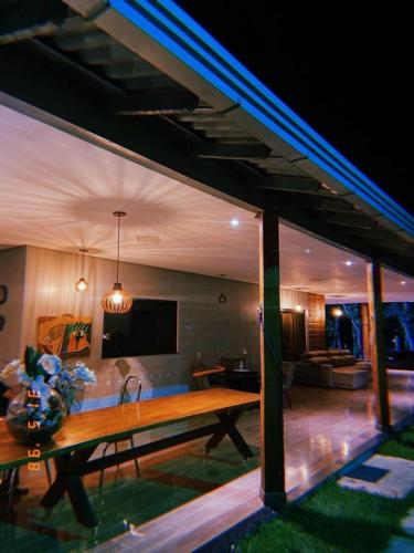 a living room with a table and a couch at Pousada Rekantu do Poeta in Alter do Chao