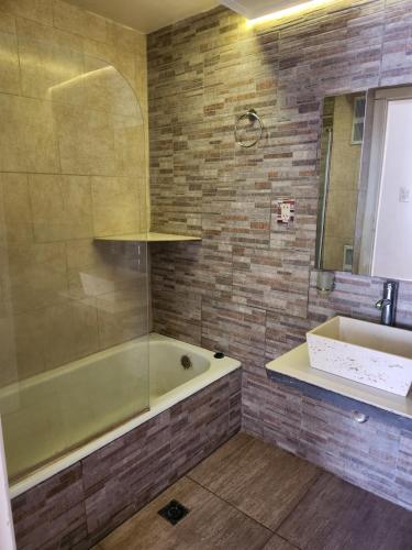 een badkamer met een bad en een wastafel bij casa de verano centro Necochea in Necochea