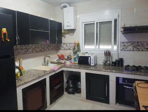 a kitchen with a sink and a counter top at Two bedroom with garden in Constantine