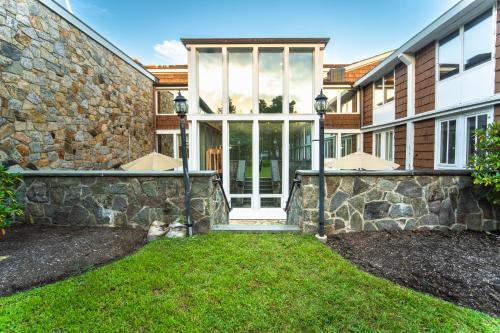 a home with a stone wall and a front door at Sleepy Hollow Hotel in Tarrytown