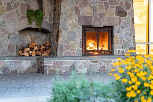 a stone fireplace with a pile of fire wood at Sleepy Hollow Hotel in Tarrytown