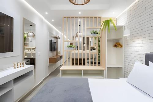 a bedroom with a bed and a tv in a room at Copa Beach Studios Design in Rio de Janeiro