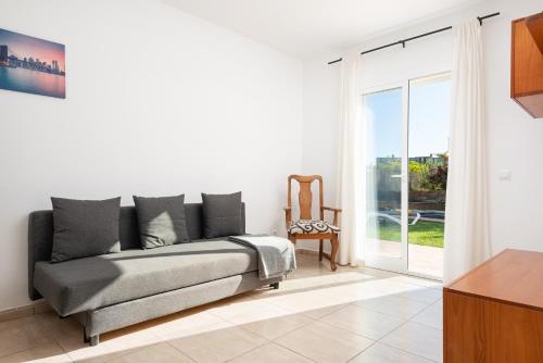 a living room with a couch and a sliding glass door at Impresionante Villa Son Ganxo II en Cala Murada! in Cala Murada