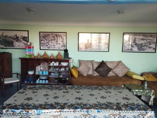 a bedroom with a bed and some pictures on the wall at Dar El jadida in El Jadida