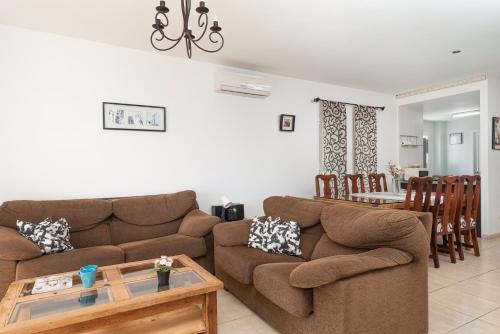 a living room with a couch and a table at Impresionante Villa Son Ganxo II en Cala Murada! in Cala Murada