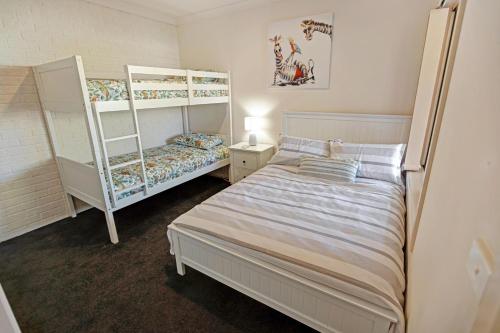 a bedroom with two bunk beds and a bed at Pelican Brief in Paynesville