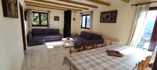 a living room with two blue couches and a table at Autxikoborda in Elbete