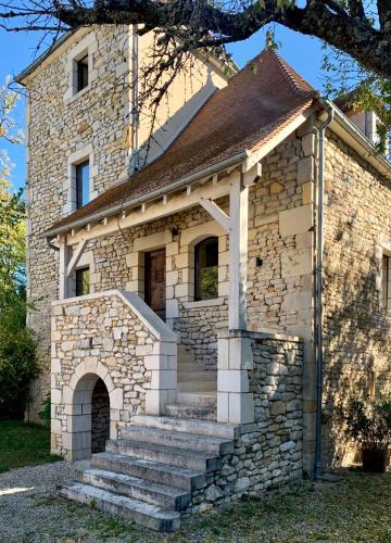 a stone house with stairs in front of it at Manoir La Barriere - Lot in Le Vigan