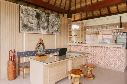 a kitchen with a desk with a laptop on it at Camaradvipa Retreat Munduk in Munduk