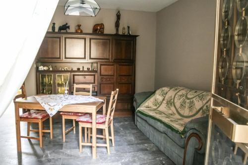 a dining room with a table and a bed at Brother's Home in Civitella Casanova