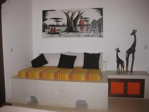 a bedroom with a bed with two giraffes on it at Watamu Villa With Service Personnel in Watamu