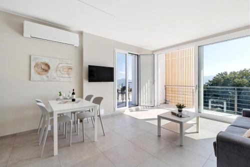 a living room with a white table and chairs at Residence Conca Verde 2 with pool in Trarego Viggiona