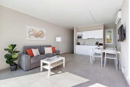 a living room with a couch and a table at Residence Conca Verde 2 with pool in Trarego Viggiona