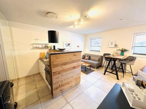 a living room with a kitchen and a dining room at Ferienwohnungen Mountainfloor - Chiemgau Karte in Inzell
