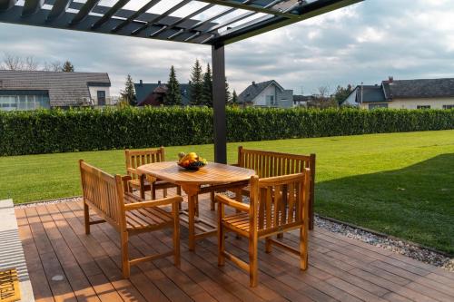 a wooden table and chairs on a patio at Luxury Resort Potatoland in Šenčur