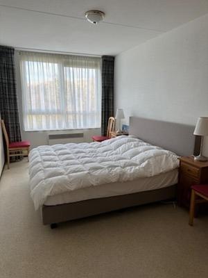 a bedroom with a large bed and a window at Ostrea 4 in Nes