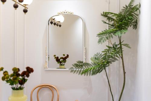 a mirror on a wall next to a table with plants at Shanghai Yi Du B&B - Family Suite 500m to Nanjing West Rd Near People's Square -Credit Cards Accepted in Shanghai