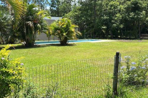 a fence in front of a yard with a swimming pool at Quinta con piscina Laguna Sur Bitcoins House in Corrientes