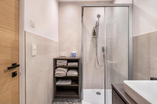 a bathroom with a shower and a sink at Mountain Meadows Apt 4 in Valdaora