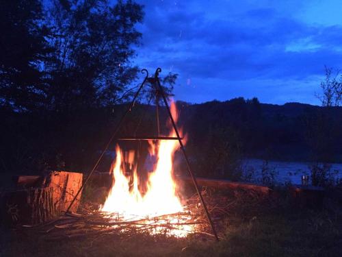 a fire pit is lit up at night at Gościniec pod Skółką in Łącko