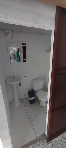 a small bathroom with a toilet and a sink at Casa travesia in Ayampe
