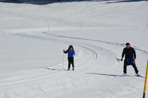 a man and a woman on skis in the snow at Casa Danoli in Canale San Bovo