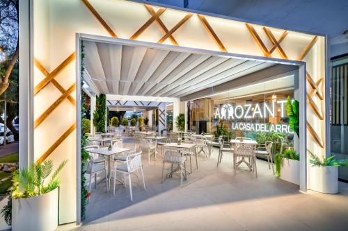 a restaurant with tables and chairs inside of a building at Occidental Puerto Banús in Marbella