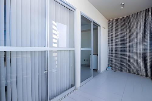 an empty hallway with glass doors in a building at Ozped Private Flats Manhatan in Brasília