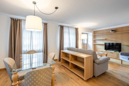 a living room with a glass table and a couch at Chalet Falorie in Cortina dʼAmpezzo