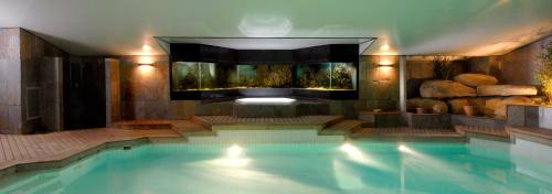 a large swimming pool in a house with a swimming pool at Domaine de la Butte Ronde in La Boissière-École