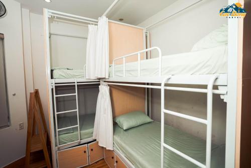 a bunk room with two bunk beds and a window at Cốm Homestay Cao Bằng in Cao Bằng