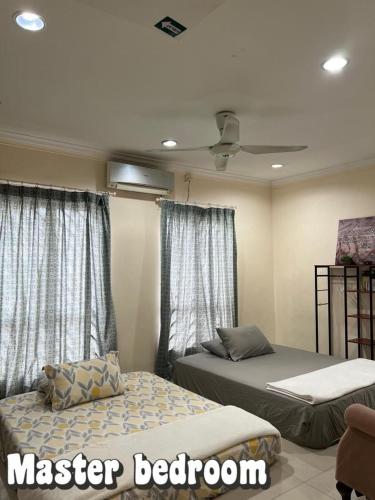 a bedroom with two beds and two windows at Homestay GG Greenwood Gombak in Batu Caves