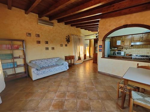 a living room with a couch and a kitchen at B&B Camera delle Camelie in Palestrina