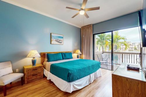 a bedroom with a bed and a balcony at Salt & Serenity in Siesta Key