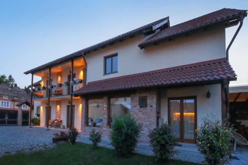 a large white house with a lot of windows at AMA Guest House in Turda