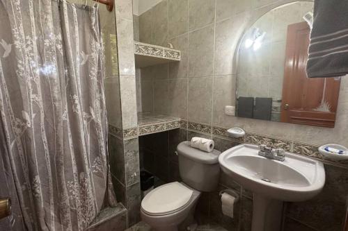 a bathroom with a toilet and a sink at Casa Linda Villa 45 - Sosua in Sosúa