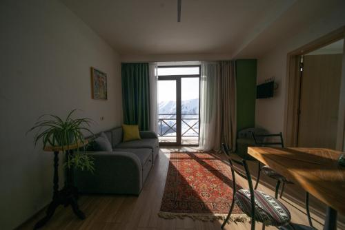 a living room with a couch and a table at Chalet Papa Basili in Gudauri