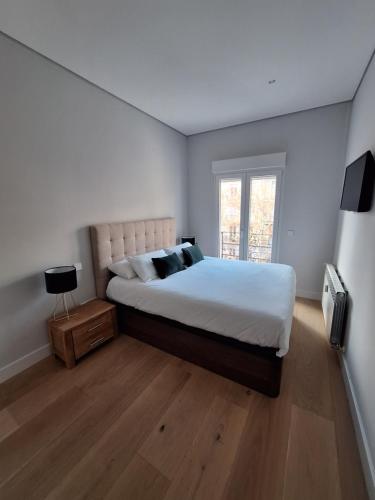 a bedroom with a large bed and a window at Salamanca Views in Madrid