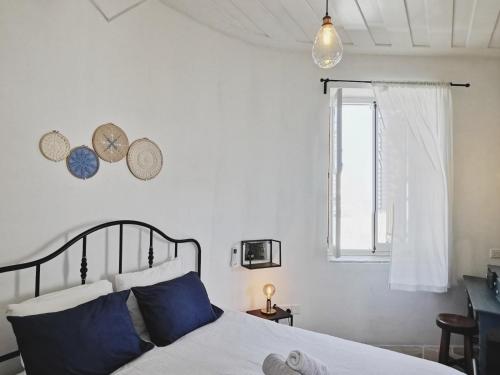 a bedroom with a bed and two clocks on the wall at 7Kamares in Pano Lefkara