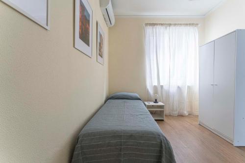 a bedroom with a bed and a white cabinet at Spacious Apartment in Sori with Large Terrace in Sori