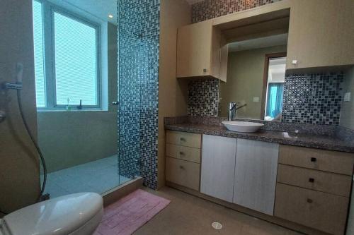 y baño con aseo, lavabo y ducha. en Apartment in the Causeway Amador en Panamá