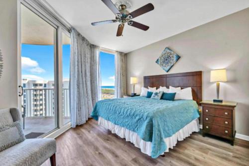 a bedroom with a bed and a view of the ocean at Palms of Destin 21211 in Destin
