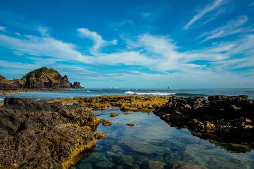 a view of the beach with rocks and the ocean at Engenho Hostel in Lajes do Pico