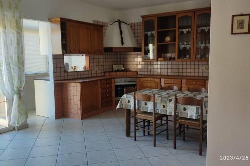 uma cozinha com uma mesa e cadeiras em La casa vacanza di Jano em Francavilla di Sicilia