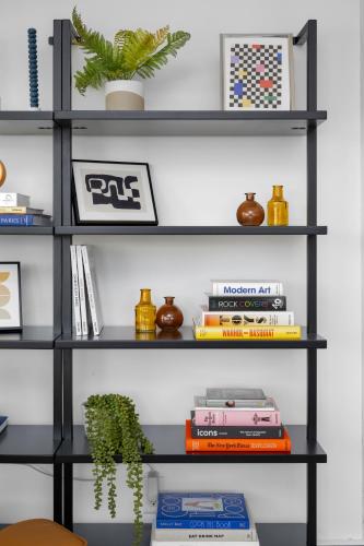 a black book shelf with books and a plant at Renovated 3BD 2BA Escape w Hot Tub and City Views in Salt Lake City