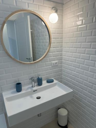 a bathroom with a white sink and a mirror at Titti guest-house in Finale Ligure