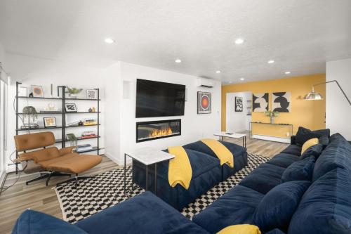 a living room with a blue couch and a fireplace at Renovated 3BD 2BA Escape w Hot Tub and City Views in Salt Lake City
