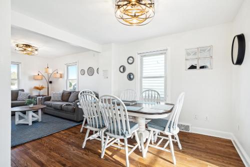 a living room with a table and chairs and a couch at Logan's House in Downtown Frederick in Frederick